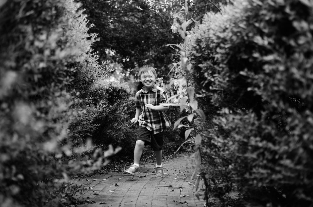 black and white photo of child running